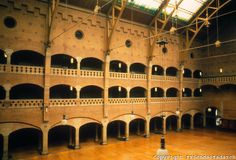 the inside of an old brick building with multiple balconies