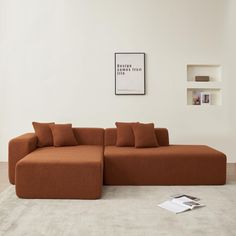 an orange couch sitting on top of a white rug