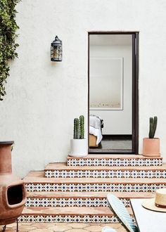 there is a potted plant sitting on the steps next to some pots with plants in them