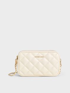 This mini Apfra bag is practical and polished at once. From the beautiful cream hue to the luxuriously plush quilted finish, this is a timeless bag that you can easily dress up or down. While compact in size, it offers ample room to hold all your everyday essentials -- it certainly makes for a great travel companion. Plus, it comes with an adjustable braided strap that is also detachable, so you can use it as a pouch that slots easily into your day bag. White Quilted Bag For Formal Occasions, White Quilted Evening Bag, Classic Quilted Rectangular Bag, Elegant White Quilted Bag, Luxury Quilted Pouch Bag, Luxury Quilted Beige Bag, Beige Quilted Evening Bag, Beige Quilted Evening Shoulder Bag, Luxury Quilted Cream Shoulder Bag