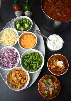 several bowls of food are arranged on a table