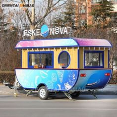 a small blue and yellow trailer parked in front of a building