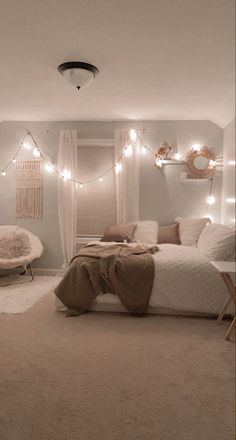 a bedroom with lights strung from the ceiling