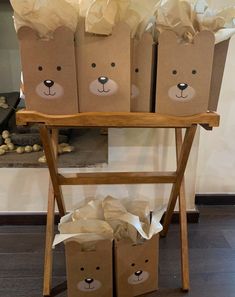 some brown paper bags are sitting on a wooden stand with two bears painted on them