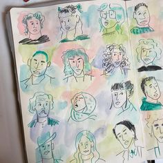 an open notebook with drawings of people on it