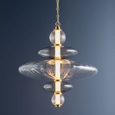 a glass chandelier hanging from a gold chain