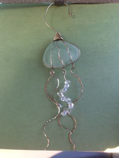 a piece of wire with glass beads hanging from it