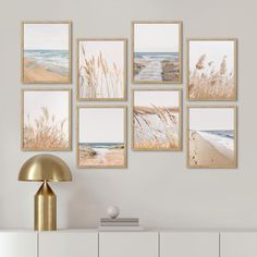 a set of six framed pictures hanging on a wall above a white dresser in a living room