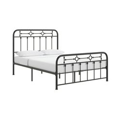 an iron bed frame with white sheets and pillows on it, against a white background