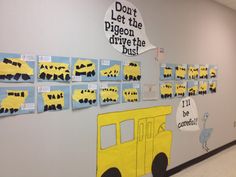 a school hallway decorated with bulletin boards and pictures on the wall that say don't let the pigeon drive the bus