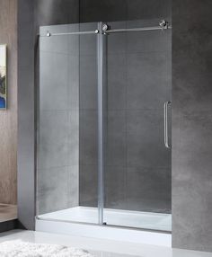 a bathroom with a glass shower door and white rug on the floor next to it