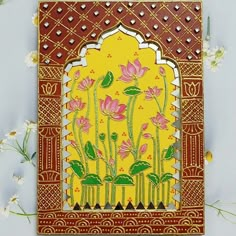 an intricately decorated card with pink flowers on yellow and red background, surrounded by small white flowers