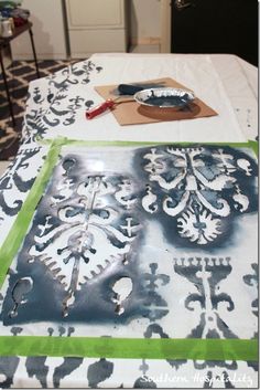 an image of how to stencil draperies on a table with green tape