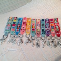 a bunch of key chains that are laying on a bed