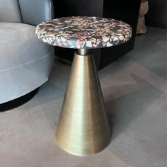 a small table with a flowered top on it in the middle of a room