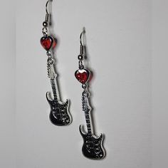 These Unique Guitar Earrings Are A Must-Have For Any Music Lover. The Dangle/Drop Style With A Hook Closure Is Perfect For Everyday Wear And The Red Heart-Shaped Stone Adds A Pop Of Color To Any Outfit. The Earrings Are Designed For The Lobe Area And Are Perfect For Anyone Who Loves The Sound Of Music. The Earrings Are Categorized Under Jewelry & Watches And Fashion Jewelry, Specifically Earrings. The Blue Color And Guitar Theme Make Them A Great Addition To Any Jewelry Collection. These Earring Guitar Earrings, The Sound Of Music, Unique Guitars, Sound Of Music, Music Lover, The Sound, Red Heart, Heart Charm, Jewelry Watches