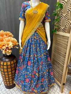 Discover timeless elegance with Anandi Fashions' Customized Half Saree set for young women. This unique ensemble features a captivating Royal Blue and yellow combination Kalamkari Half Saree--perfectly crafted for teens and young women seeking both tradition and style. Each piece embodies our commitment to quality and fashion, ensuring you stand out at any festive or special occasion. Explore the charm of Indian ethnic wear with this exquisite half saree, exclusively available at Anandi Fashions Blue Kalamkari Pre-draped Saree For Diwali, Festive Fitted Dupatta With Kalamkari Print, Fitted Dupatta With Kalamkari Print For Festive Occasions, Yellow Semi-stitched Sets For Navratri, Multicolor Anarkali Style Pre-draped Saree With Printed Motifs, Anarkali Style Multicolor Pre-draped Saree With Printed Motifs, Fitted Salwar Kameez With Kalamkari Print And Traditional Drape, Unstitched Art Silk Lehenga With Printed Motifs, Festive Kalamkari Anarkali Set With Traditional Drape