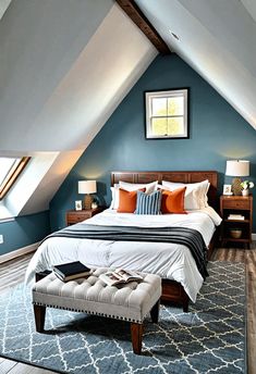 a bedroom with blue walls, white bedding and an ottoman on the floor in front of it