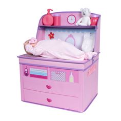 a pink toy chest with a doll sleeping in it