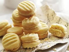 a pile of cookies sitting on top of a white plate next to a piece of paper