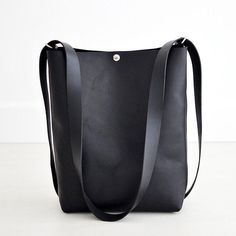 This convertible backpack, the Crossback 3-in-1 Bag, is as beautiful as it is practical! Convert from shoulder or crossbody to a backpack with this one bag!Black LeatherBlack Leather Straps...• Fast & FREE USPS Shipping• Made with a single piece of Full-Grain leather• Top extender• Open interior pocket• Shiny nickel hardware• Measurements: 14" wide across top, 11” wide across bottom, 15" high, 5" deep• Handle drop length is 18” - longer strap available upon request• Includes key-clip• Handmade i Minimalist Bucket Bag With Detachable Strap, Modern Crossbody Leather Backpack For Errands, Minimalist Leather Backpack With Adjustable Strap For On-the-go, Modern Leather Crossbody Backpack For Errands, Minimalist Leather Backpack With Adjustable Strap For Everyday Use, Minimalist Leather Backpack With Adjustable Strap, Minimalist Crossbody Bucket Bag For Travel, Soft Leather Backpack Shoulder Bag For Everyday, Modern Leather Crossbody Backpack For Everyday