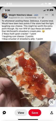 a person holding up a piece of bread with toppings on it