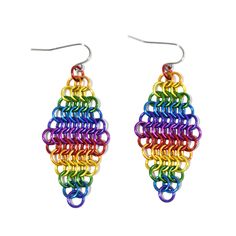 a pair of earrings with multicolored rings hanging from it's ear wires