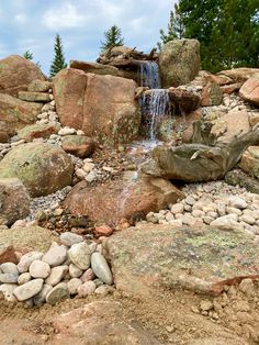 a small waterfall in the middle of some rocks