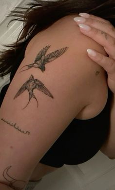 a woman with a bird tattoo on her arm