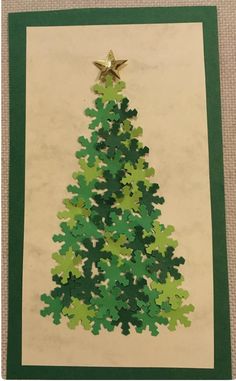 a christmas tree made out of puzzles on a piece of paper with a star