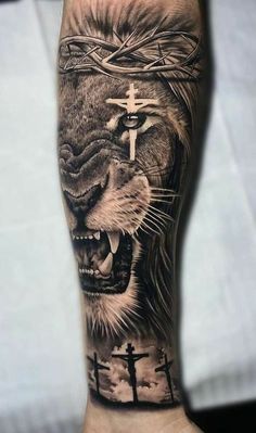 a man's arm with a lion and cross on it