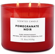 a red candle with a label on it that says, pomegranate noir