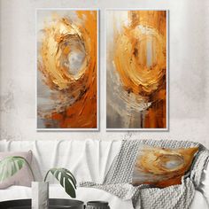 two paintings on the wall in a living room