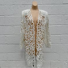 Intricate Eyelet Cut-Outs And A Beaded Finish By Moshita Couture. Tailored In Fit, Shoulder Pads, Excellent Like New Condition. Size 14 Fits Medium Large. Summer Sequined Outerwear, Long Sleeve Summer Evening Outerwear, Summer Evening Long Sleeve Outerwear, Spring Embellished Long Sleeve Blazer, White Embellished Long-sleeved Blazer, Elegant Spring Cardigan With Sequins, Elegant Sequined Cardigan For Spring, Elegant Spring Sequin Cardigan, Spring Party Embellished Outerwear