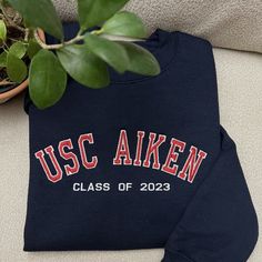 "If you want sleeve embroidery, add this add-on to your cart: https://customembshirts.etsy.com/listing/1156973414 One stitch at a time, let's create something beautiful together. Our custom embroidered sweatshirts are the ultimate personalized gift for any occasion. These cozy essentials are available as crewnecks or hoodies and feature from minimalist to classic jersey-style embroidery for a touch of nostalgia and personalization. Crafted for both comfort and style, these sweatshirts offer a un College Hoodie With Letter Embroidery And Long Sleeves, College Hoodie With Letter Embroidery, School Spirit Crew Sweatshirt With Letter Embroidery, Varsity Sweatshirt With Letter Embroidery For College, Crew Neck Sweatshirt With Letter Embroidery For School Spirit, School Spirit Letter Embroidery Crew Sweatshirt, Long Sleeve Sweatshirt With School Spirit Embroidery, School Spirit Long Sleeve Embroidered Sweatshirt, College Crew Sweatshirt With Embroidered Logo