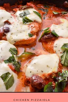 chicken pizza with basil and mozzarella sauce in a black pan on a pink background