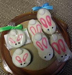 four decorated cookies in the shape of bunny ears