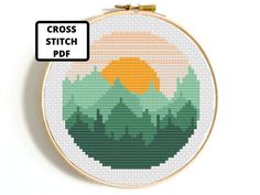 the cross stitch pattern is in progress to make it look like an embroidery art piece