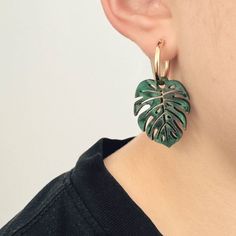 For all the plant lovers, the Monstera Hoop Earrings are a lovely, leafy addition to your wardrobe. The leaf charms are laser cut from a glossy green-marbled acrylic and can be purchased on their own or with the option of 14k gold-filled or sterling silver hoops. Their super lightweight design ensures you can enjoy the beauty of your favorite foliage without any discomfort, perfect for wearing from morning to night. Each pair of Monstera Hoop Earrings is lovingly handmade in our London studio. When it comes to gifting, these earrings come beautifully presented in a logo box, making them an ideal gift for the plant enthusiast in your life or a special treat for yourself. Laser Cut Wood Crafts, Laser Cut Earrings, Cut Earrings, Leaf Charms, Sterling Silver Hoops, Silver Hoops, Laser Cut, Gold Filled, Hoop Earrings