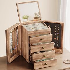 an open jewelry box on a wooden table