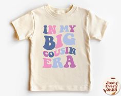 In my Big Cousin Era, Trendy Kid Shirt, ,Funny Toddler Shirt, Pregnancy Reveal T-Shirt, Siblings Shirt,  Cousin Natural Body, Cousin Sweater ✧ All of the t-shirts and bodysuits at our shop are made of 100% certified pure organic cotton. Elegant t-shirt with round neckline and short sleeves. The loose fit and softness of the cotton gives you freedom of movement. ✧Our sweatshirts are very soft, cute and lightweight, bound to keep you warm. Kid's unisex cotton blouse made of cotton with elastic at Playful Letter Print T-shirt For Gender Reveal, Fun Tops With Funny Print For Gender Reveal, Funny Toddler Shirt, Funny Toddler, Sibling Shirts, Toddler Humor, Pregnancy Reveal, Trendy Kids, Cotton Blouse