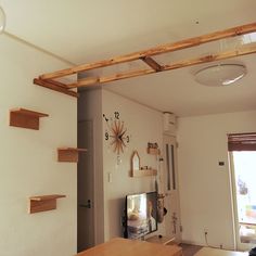 a living room filled with furniture and a flat screen tv sitting on top of a wooden table