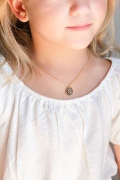 "A cute toddler, baby, or little girl coin disc initial necklace. This adorable initial necklace makes the perfect personalized gift for any girl, any age! They will smile with excitement when they unbox their very own cute initial necklace! It's simple, classic design will be popular and trendy for many years to come. Each shiny gold or silver plated initial disc charm is strung from a sturdy diamond-cut chain. Strong enough to stand up against anything your little one may do! It makes a great Cute Nickel-free Round Necklaces, Cute Personalized Adjustable Name Necklace, Cute Personalized Name Necklace, Cute Gold Name Necklace For Personalized Gift, Personalized Cute Charm Necklace For Best Friend, Cute Personalized Gold Charm Necklace, Cute Personalized Adjustable Necklace, Personalized Cute Necklaces, Cute Gold Charm Necklaces For Personalized Gifts