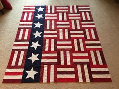 an american flag quilt is laying on the floor