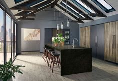 an open kitchen and dining room area with skylights above the countertop, along with bar stools