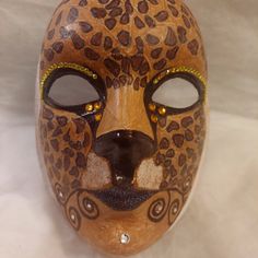 a leopard mask is shown on a white background