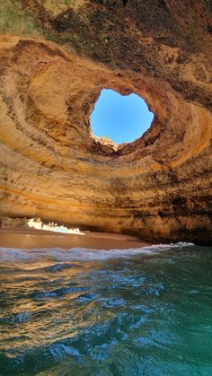 the inside of an ocean cave with blue water