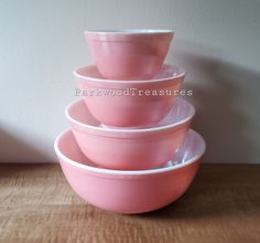 four pink bowls stacked on top of each other