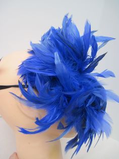 * Designed on a sturdy acrylic shiny half mask accented around the eyes with black liner and royal blue shiny embroidered flower and scrolled patterned lace in a custom design. * The right side is adorned with puffy plumes of fluffy and royal blue feathers. * To secure the mask there are two satin black ribbons on each side to be tied in the back. * A great piece for a Masked Ball, Class Reunion, Costume party or Play, Carnivale, Mardi Gras, Burlesque Occasion, Masquerade Ball, or Venetian Celeb Blue Costume Accessories For Carnival, Blue Costume Accessories For Carnival Party, Adjustable Blue Costume Accessories For Costume Party, Blue Carnival Costume Accessories, Blue Headpieces For Carnival, Mask With Feathers, Blue Feathers, Masked Ball, Half Mask