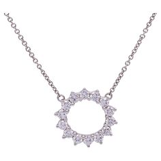 This pre-owned Tiffany & Co. Open Circle Diamond Pendant is crafted in platinum and features 14 diamonds of F color with VS and VVS clarity. The diamonds are set with shared prongs, designed to enhance their brilliance and showcase Tiffany's renowned diamond quality. The pendant measures 9.4mm on the outside and 7.6mm on the inside, offering a delicate yet substantial look. The platinum adds a comfortable weight and enhances the necklace's durability. Condition Report Pre-Owned , Excellent condition, expertly polished and Cleaned.  No scratches, No wear and tear.  Necklace Specifications Brand: Tiffany & Co. Size: Small Hallmarks: Tiffany & Co. , PT 950,  Metal: Platinum Weight: 3.6 G Length: 16.5 Inches Closure: Spring ring Clasp Outside diameter: 9.4 mm Current Retail Price: 4,700 Packag Diamond Circle Pendant, Tiffany Diamond, Louis Comfort Tiffany, Elsa Peretti, Circle Pendant Necklace, Circle Diamond, Platinum Engagement Rings, Modern Necklaces, Tiffany And Co